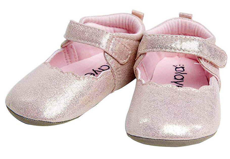 Pair of glittery baby shoes with pink soles on a white background