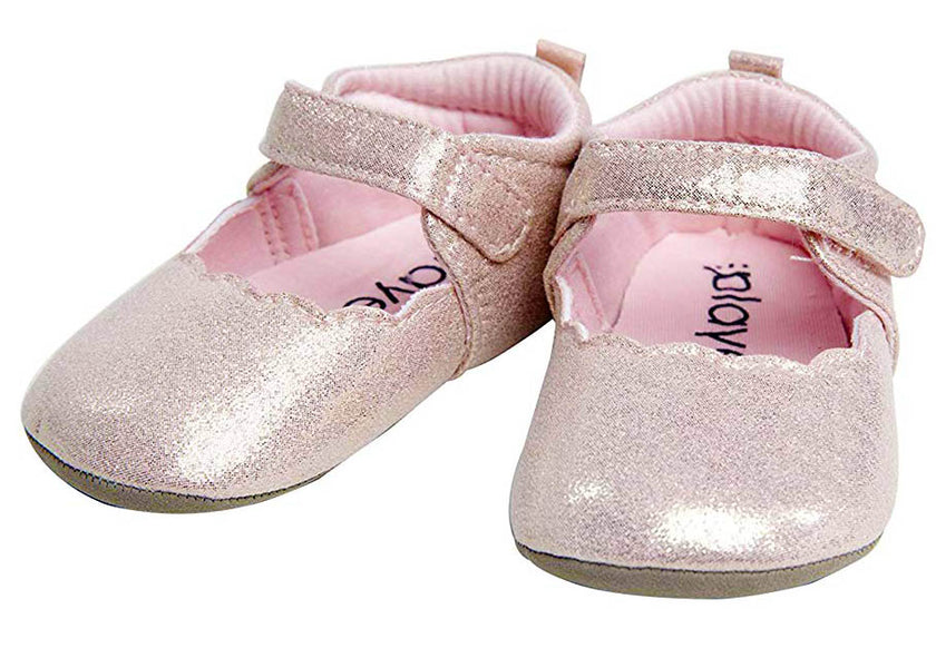 Pair of glittery baby shoes with pink soles on a white background