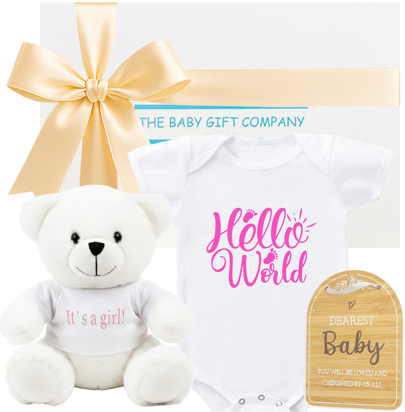 Baby gift set with white its a girl teddy bear and hello world baby romper from The Baby Gift Company.