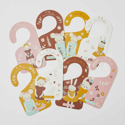 Set of baby milestone cards with cartoon characters and text on a white background