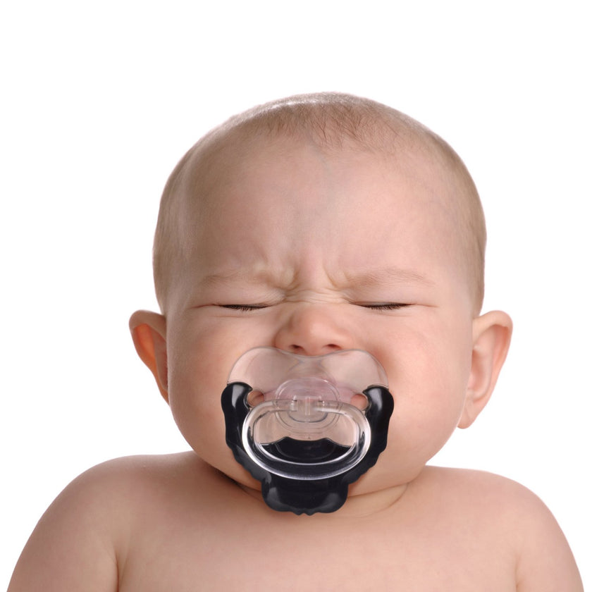 Baby with a pacifier on a white background