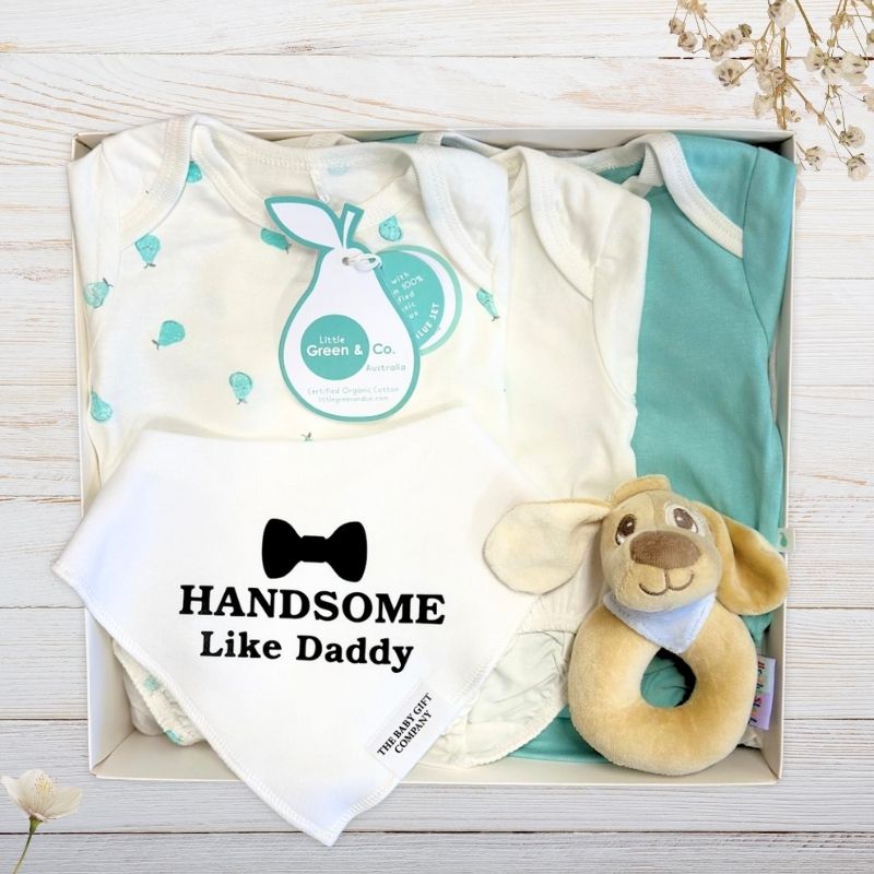 Baby gift set with baby boy onesies, handsome like daddy bib, and rattle in a gift box.