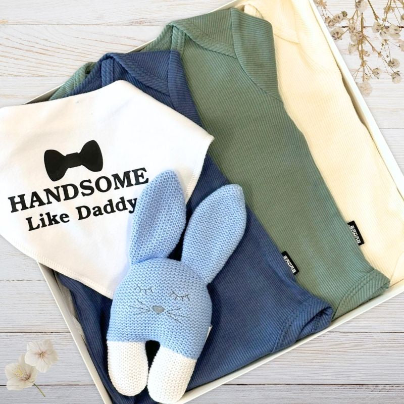 Baby clothing set with ribbed boys rompers, blue bunny toy and 'Handsome Like Daddy' bib in a box.
