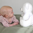 Baby with a white Teddy Bear