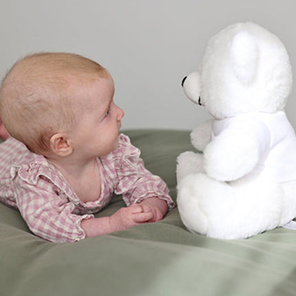 Baby with a white Teddy Bear