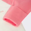 Newborn Bonds Zip Pink Wondersuit with cuffable hands on a white background