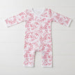 Baby onesie with red floral pattern on a white background