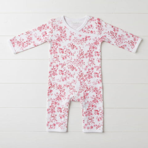 Baby onesie with red floral pattern on a white background