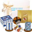 Gift set with a mug, cookies, and a box of coffee, branded by The Baby Gift Company.
