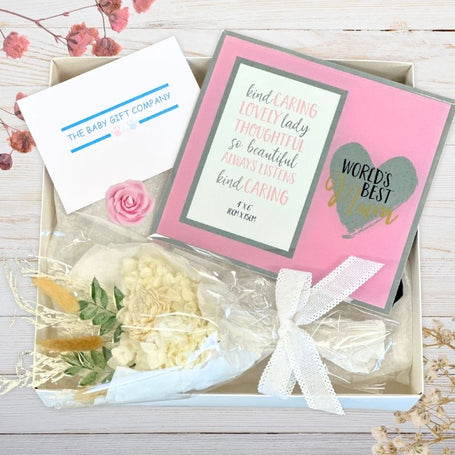 Gift box with flowers, card, and decorative elements from the baby gift company