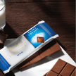 glass of milk with Lindt Excellence Milk Chocolate