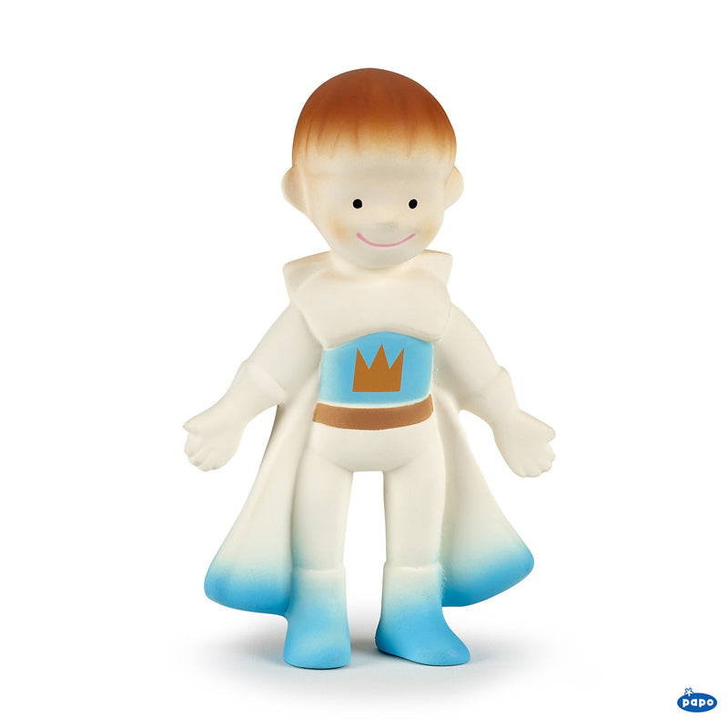 Toy figure of a character in a white and blue costume with a crown emblem on a white background