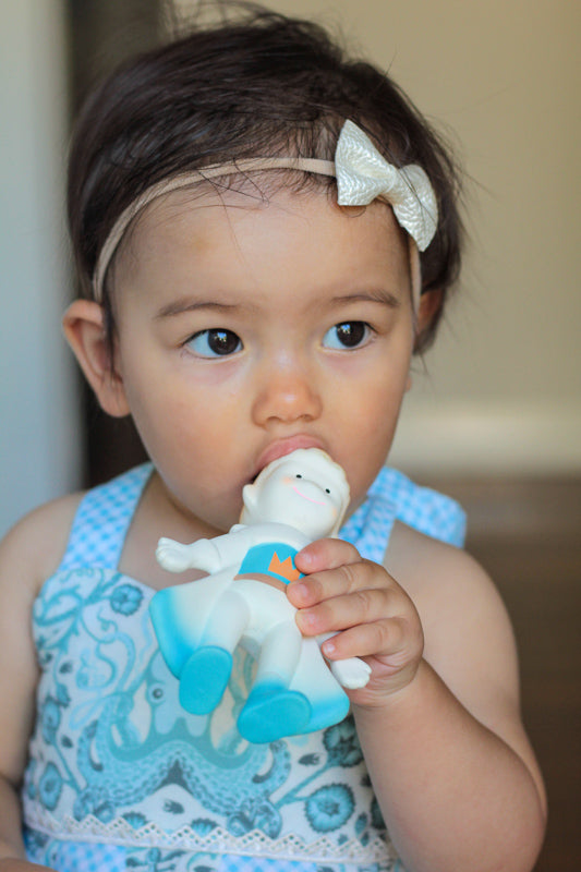 Child holding a toy with a blurred background