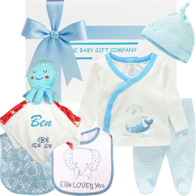 Baby gift set with clothing, bib, and plush toy from The Baby Gift Company.