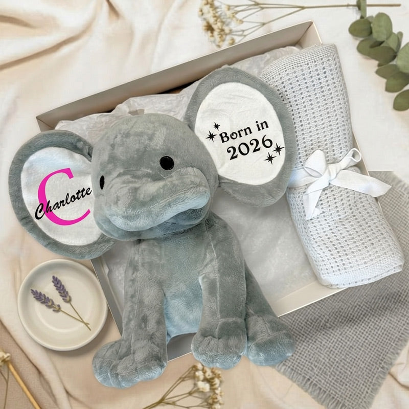 Little Bambino Personalised Baby Gift Box with grey elephant and blanket on a fabric background