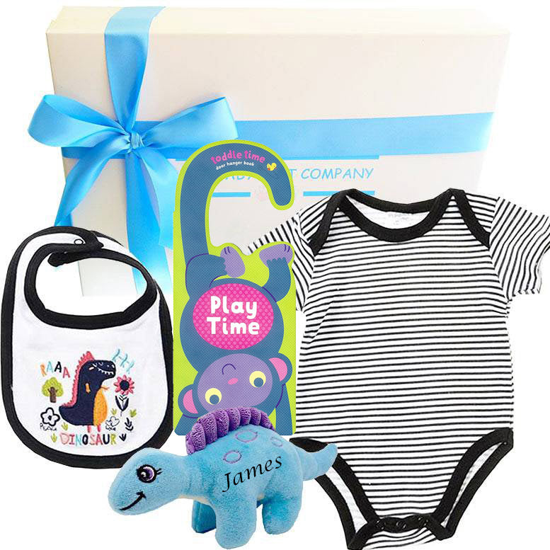 Baby gift set with onesie, bib, and toy on a white background