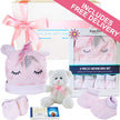 Baby gift set with pink unicorn hat, teddy bear, and baby clothes with free delivery text.