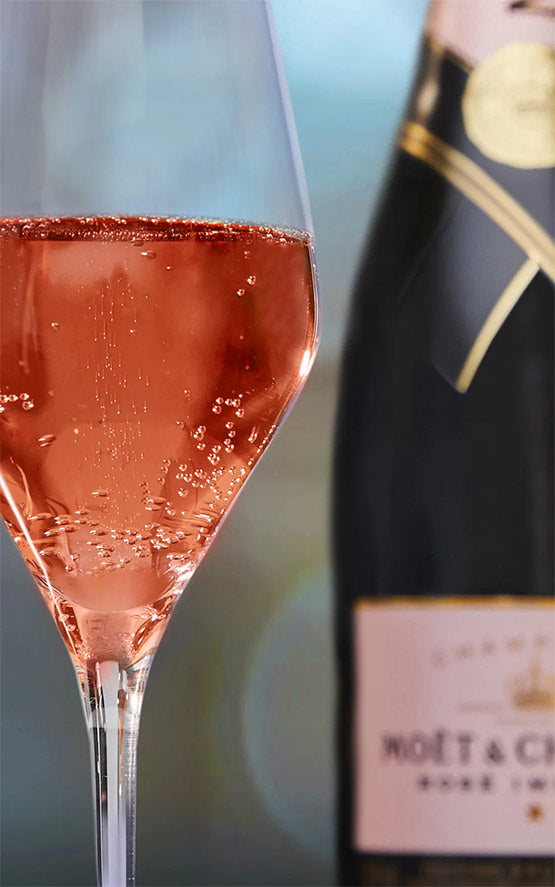 Moet & Chandon Rose Imperial champagne bottle with a glass of pink champagne.