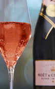 Moet & Chandon Rose Imperial champagne bottle with a glass of pink champagne.