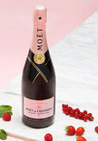 Moét & Chandon champagne bottle with pink label on a light background