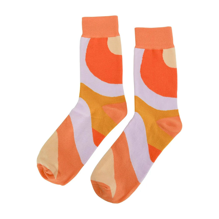 Pair of orange and beige patterned socks on a white background