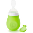 Green baby feeding spoon a white background