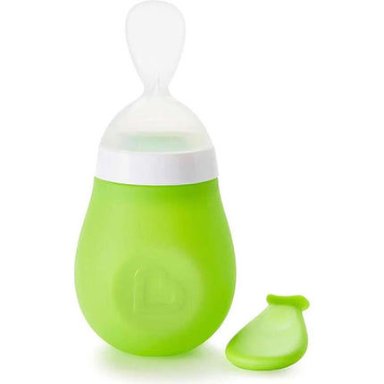 Green baby feeding spoon a white background