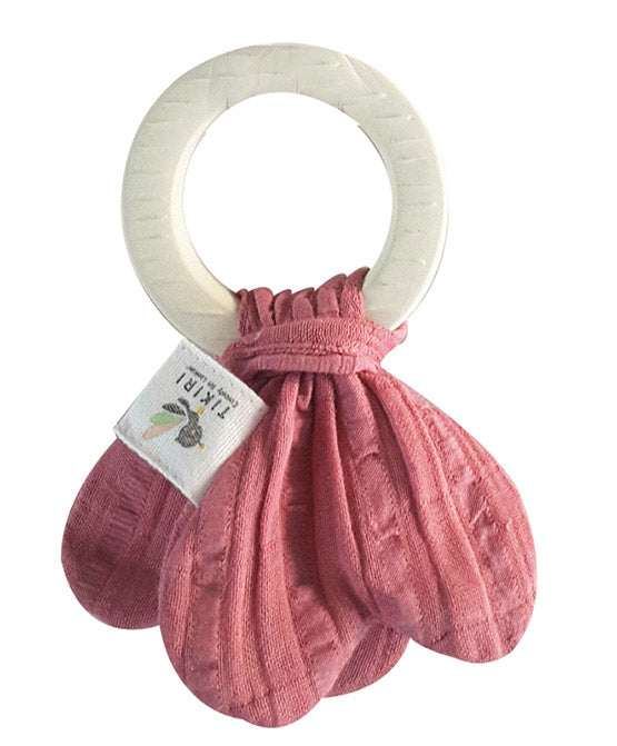 Pink textured teething ring with a white wooden ring on a white background