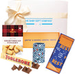 Collection of gift items including a box, cookies, Toblerone chocolate, and best dad socks in a gift box