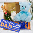Gift set with blue teddy bear, Moet champagne, Lindor chocolate, and 'Congratulations Dad' socks from The Baby Gift Company