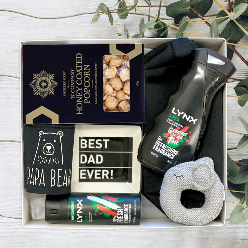 New Dad Gift set with Lynx products, a rattle toy, and a box of popcorn treats from The Baby Gift Company.