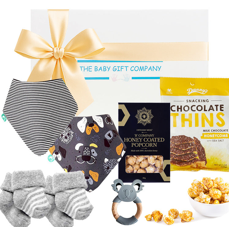 Baby gift set with popcorn, bibs, socks, and teether from The Baby Gift Company.