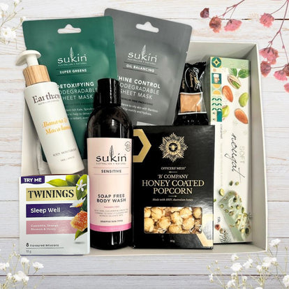 Gift box with sukin body wash, sheet masks, nourishing body moisturiser in postpartum care mum hamper