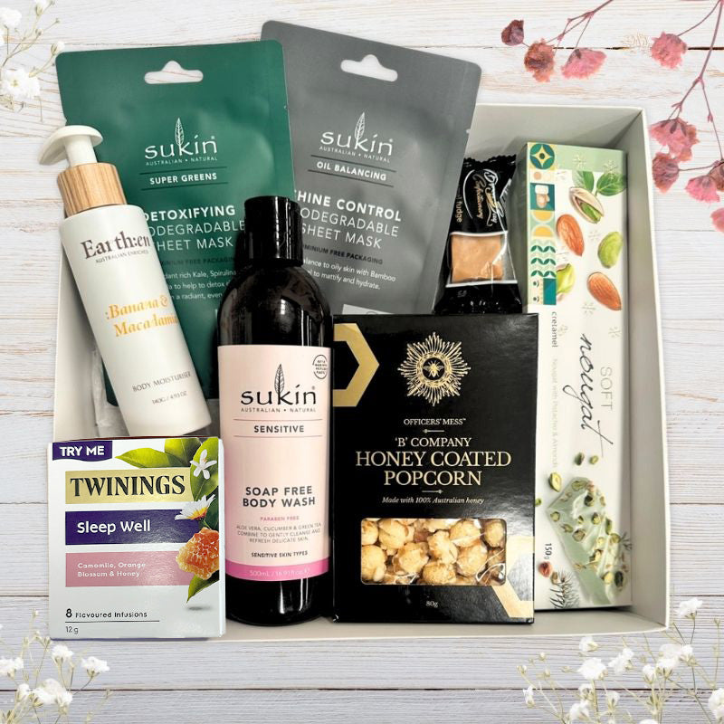 Gift box with sukin body wash, sheet masks, nourishing body moisturiser in postpartum care mum hamper