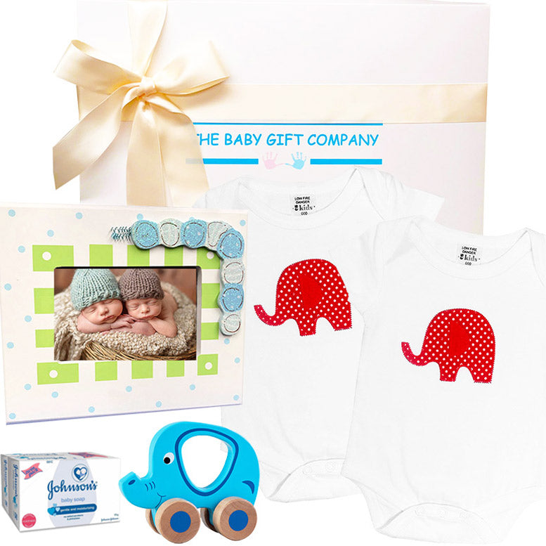 Baby gift set with photo frame, onesie, teether, and Johnson's box, branded 'The Baby Gift Company'.
