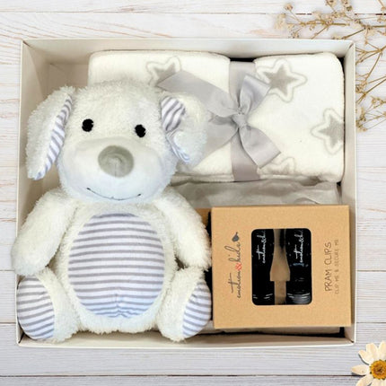 Baby gift set with plush toy, blanket, and baby socks in a box on a wooden surface.