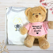 Baby onesie and teddy bear with 'Sophie' text on the Pink top, inside a gift box.