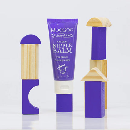 Moogoo Nipple Balm with wooden applicators on a white background