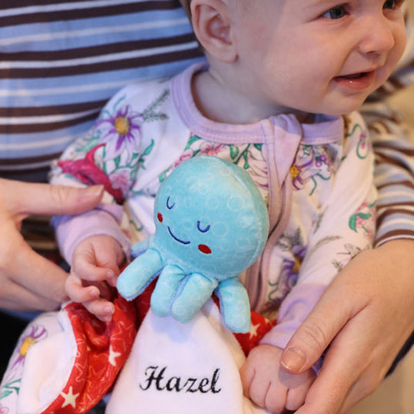 Baby girl holding Octopus Comforter Blankie