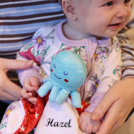 Baby girl holding Octopus Comforter Blankie