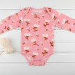 Pink baby onesie with floral pattern on a white background