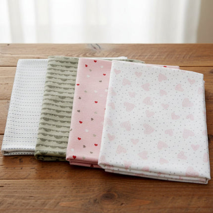 Set of four fabric swatches with different patterns on a wooden table background