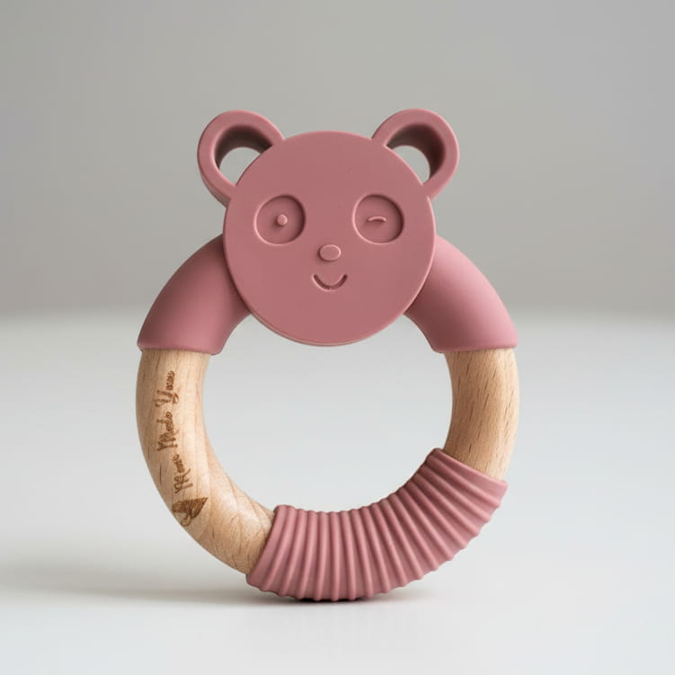 panda pink teether baby toy on table