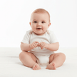 Baby wearing White baby onesie with a design on a white background