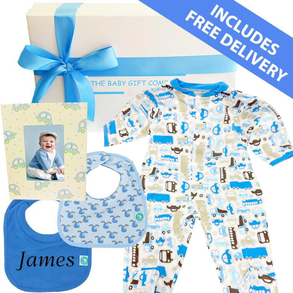 Baby gift set with pajamas, bib, and photo frame on a white background