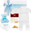 Baby gift set with light blue onesie, teddy bear, and socks from The Baby Gift Company.