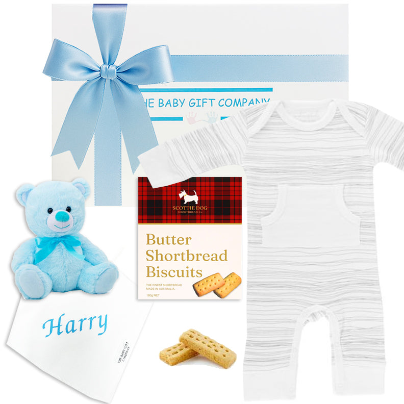 Baby gift set with light blue onesie, teddy bear, and socks from The Baby Gift Company.