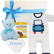 Baby gift set with striped romper, teddy bear, and baby blanket on a white background