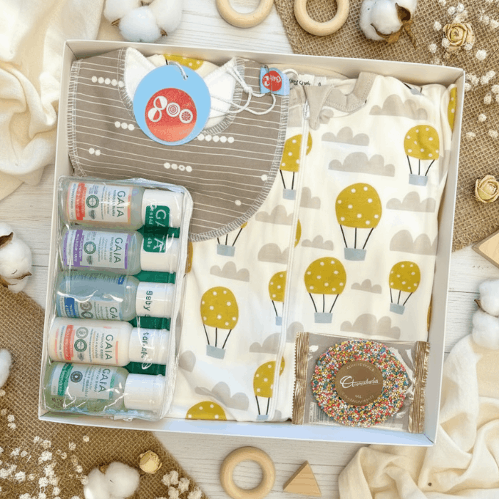 organic baby gift box with grey bib, air balloon clothing and Gaia baby skincare