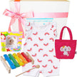 Baby gift set with baby romper, bag, photo album, xylophone, and toys on a white background.